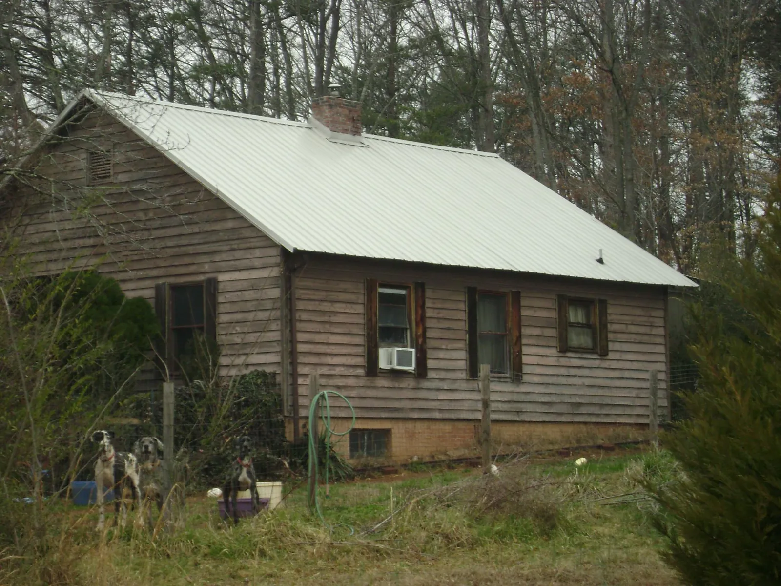 White metal roof on an old wood sided farmhouse, from a Metal Roof Installation job in Burgin
